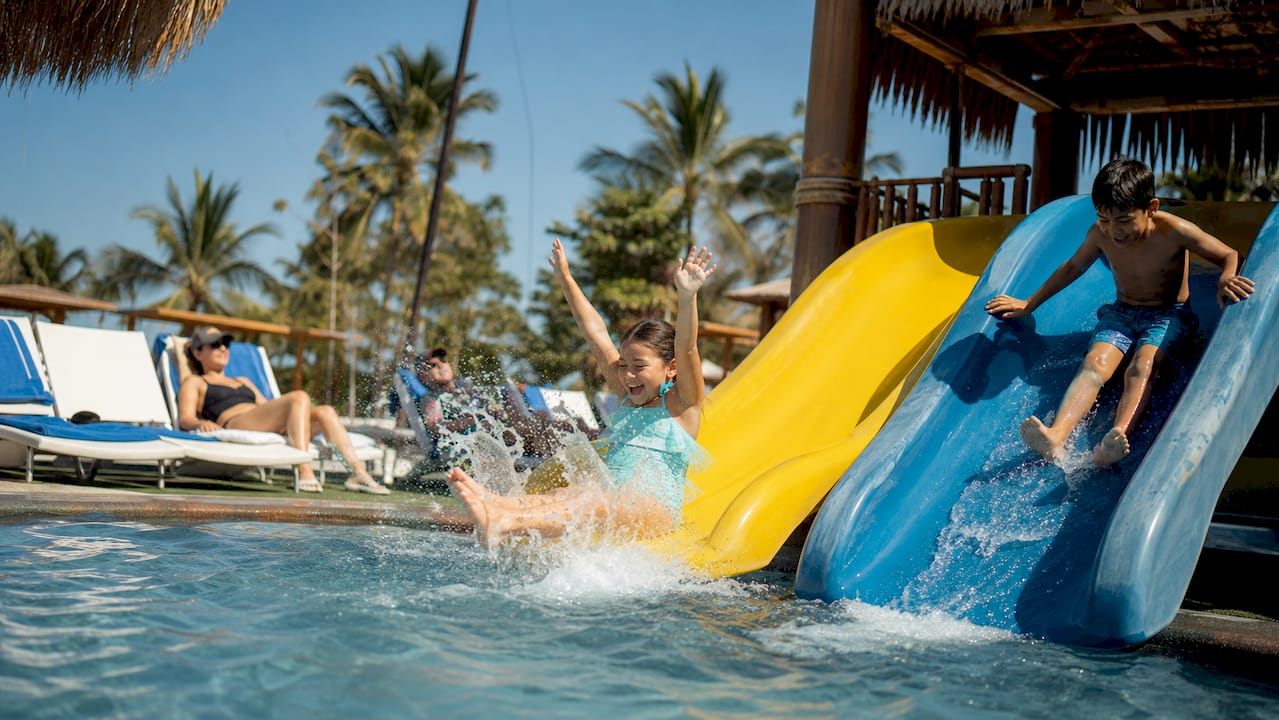 Children on water slide at family resort waterpark