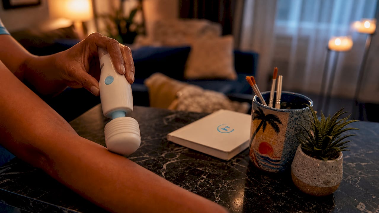 Hands testing vibration on wand massager silicone head