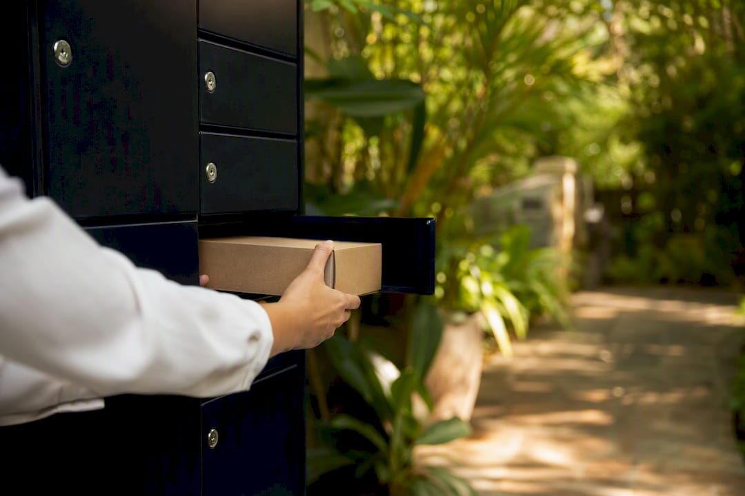 Hands opening parcel locker with discreet package