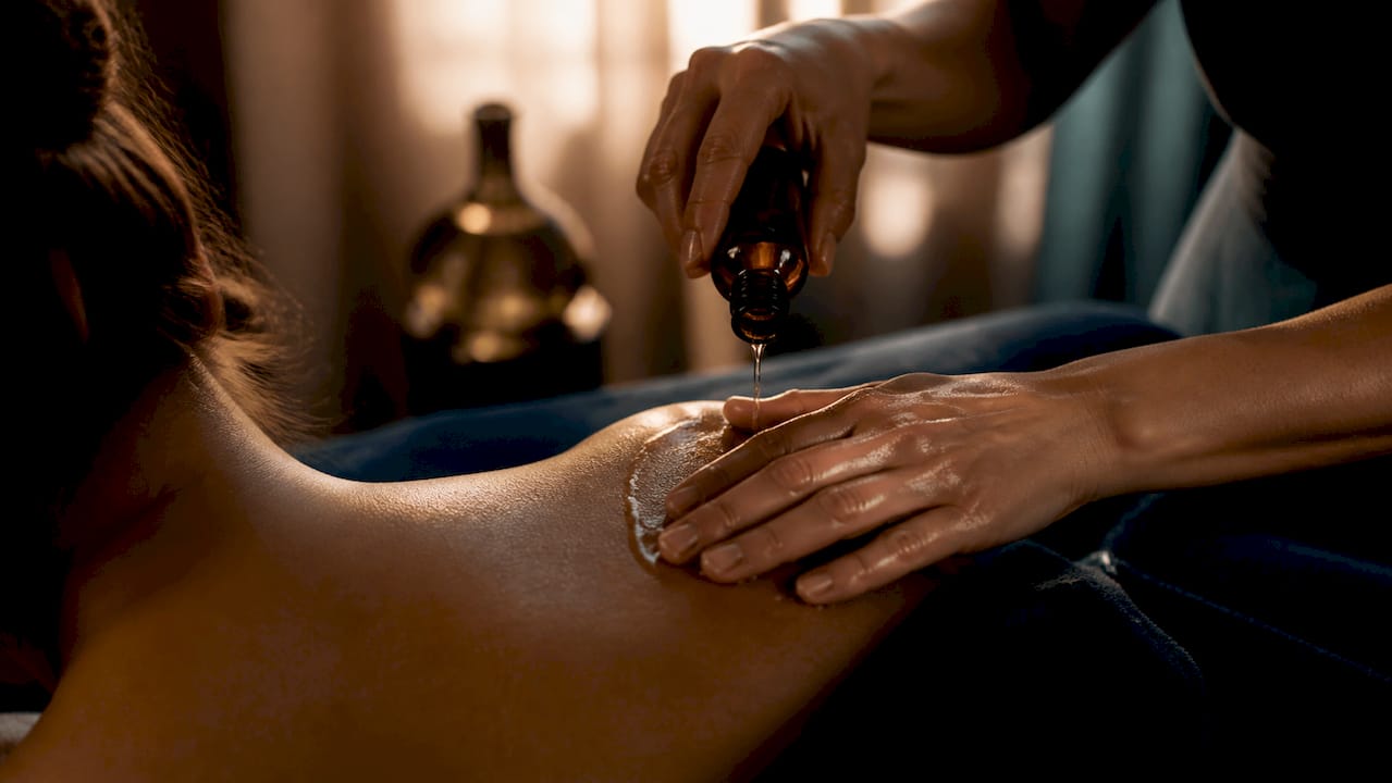 Hands applying massage oil for couples
