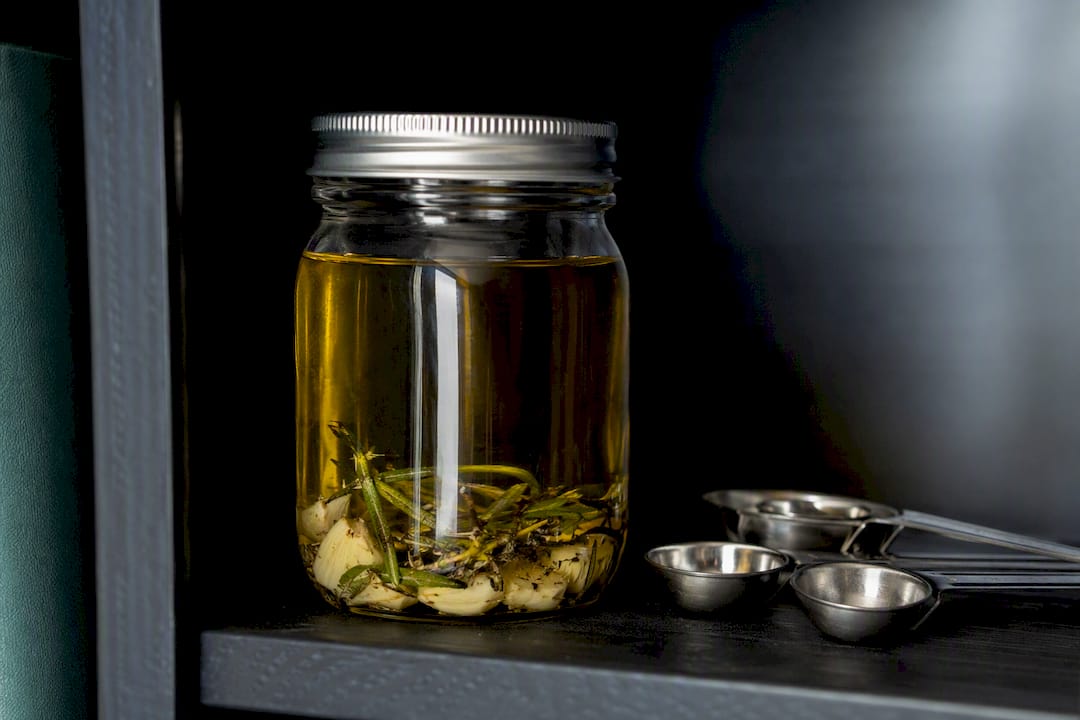 Stored oil infusion beside clean utensils