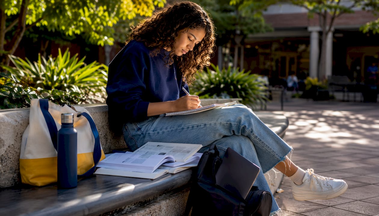 Student writing annotated bibliography notes