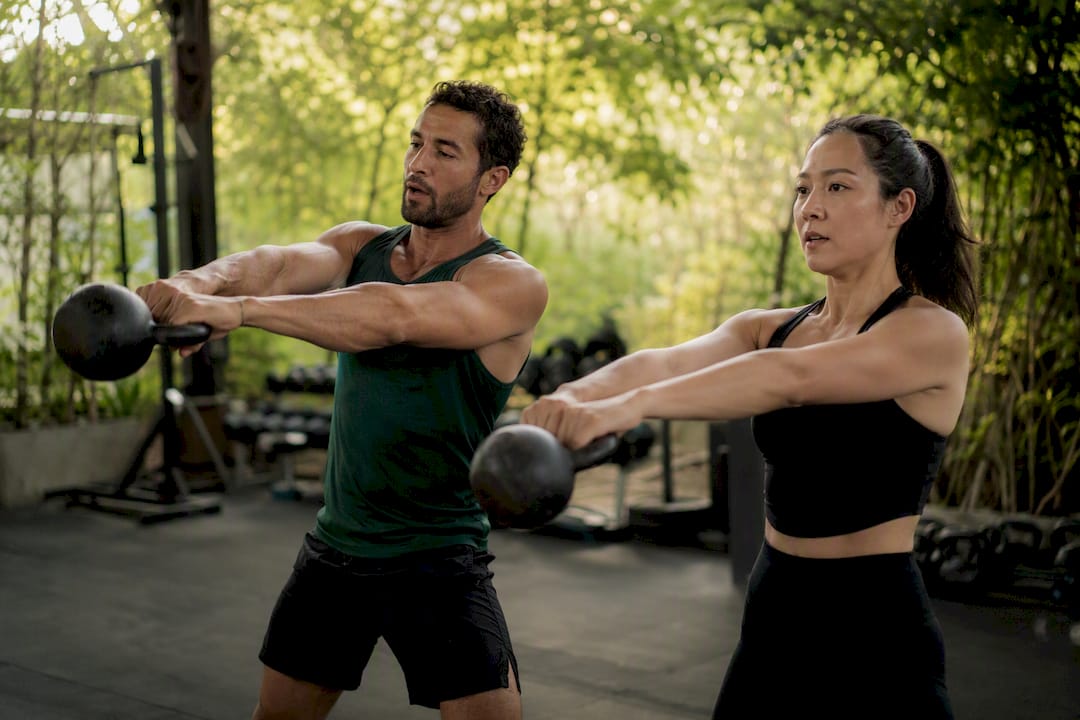 Trainer demonstrating kettlebell swing