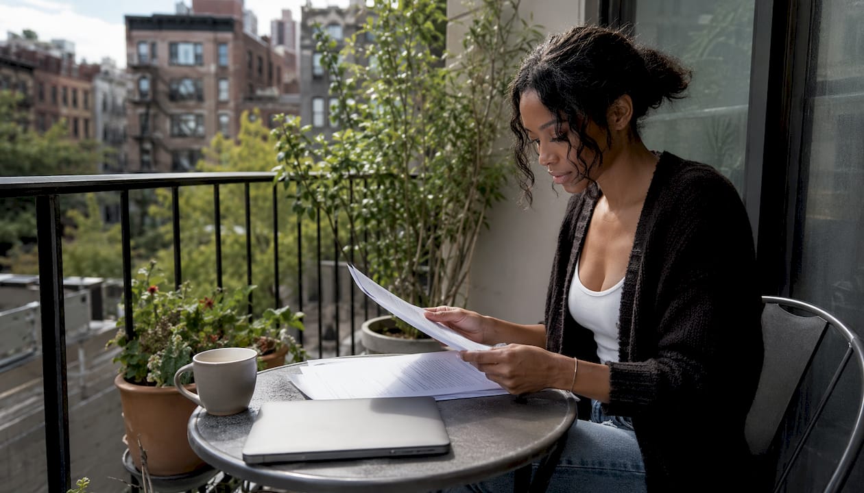 Woman reviewing NYC sublet agreement at home