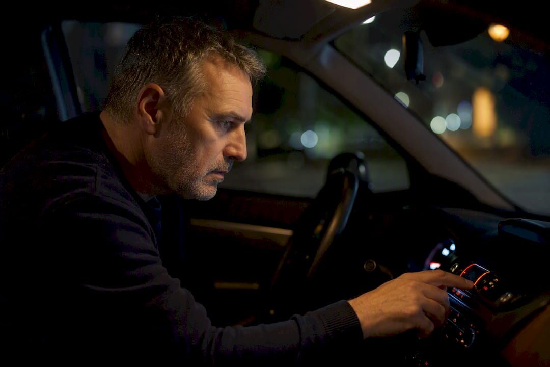 Conducteur anxieux regardant le tableau de bord