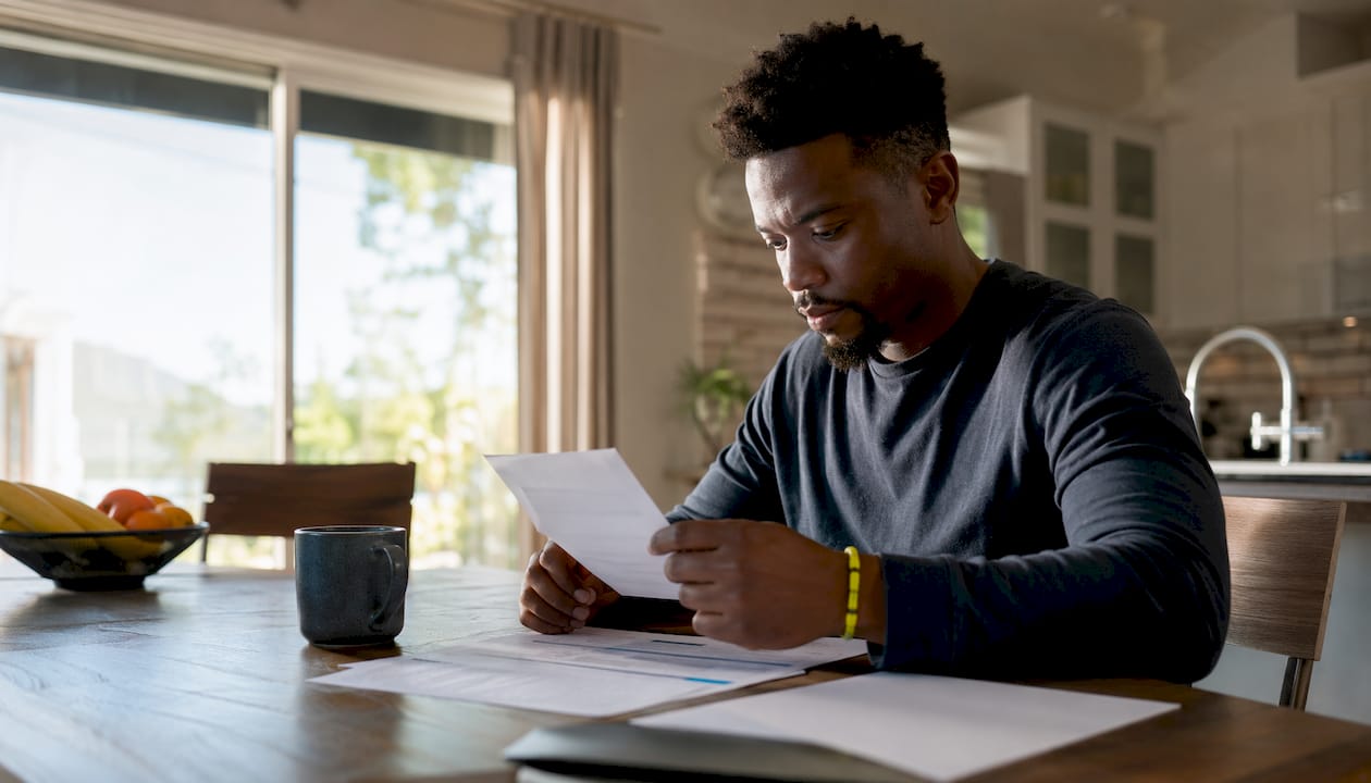 Man organizing medical records at home