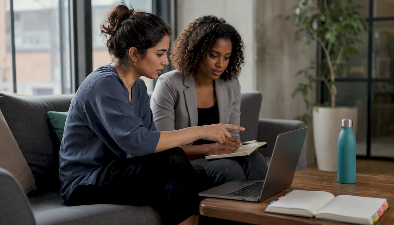 Team reviewing payroll software on laptop
