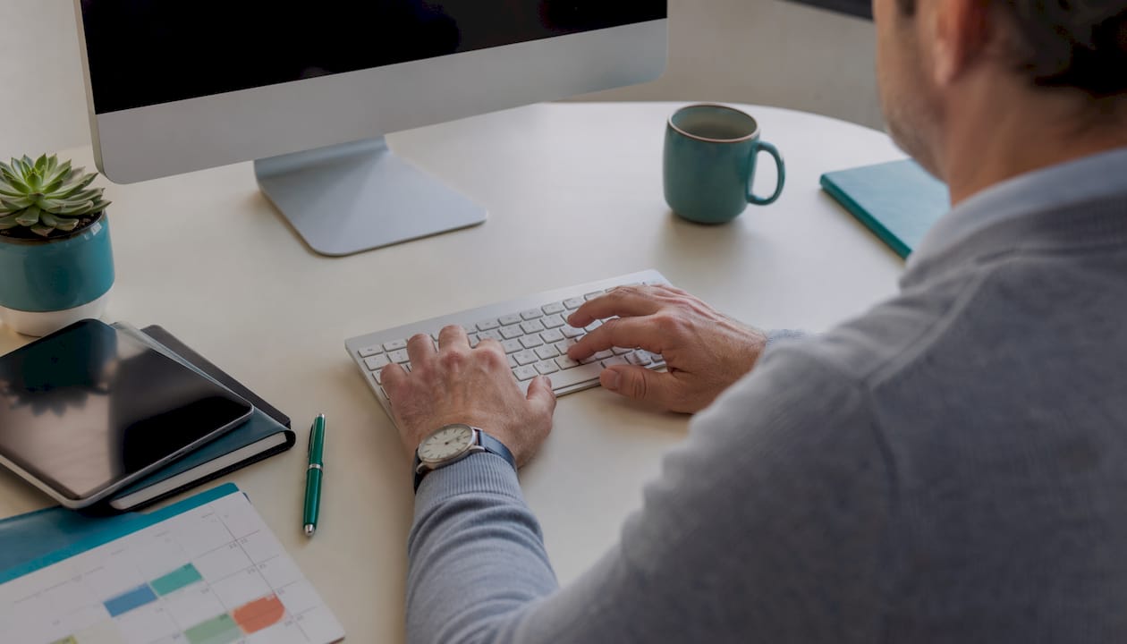 Accountant typing payroll data at desk