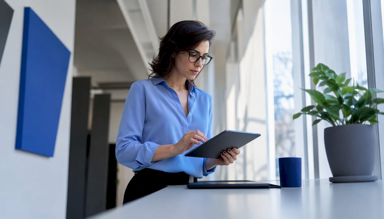 Researcher using regression software tablet in lab