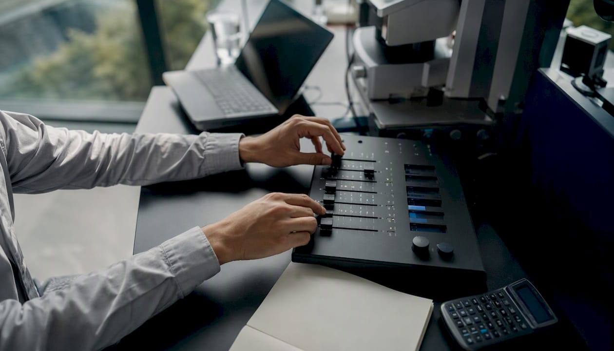 Hands adjusting analog data panel controls
