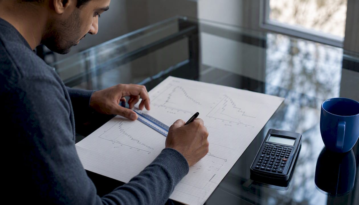 Hands sketching survival curves by pencil