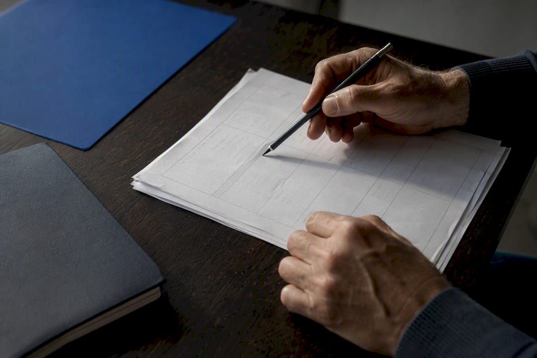 Hands reviewing analysis plan document
