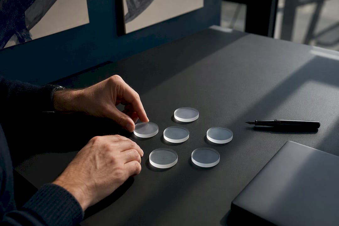 Hands arranging data ethics tokens on table