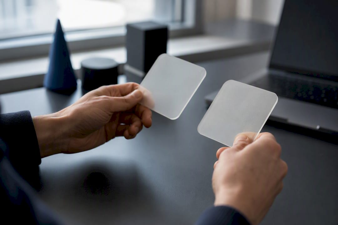 Hands holding anonymization tokens over desk