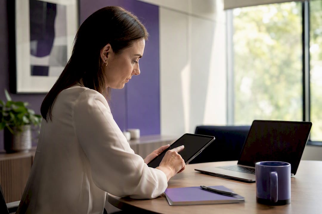 Hands managing digital compliance evidence on tablet