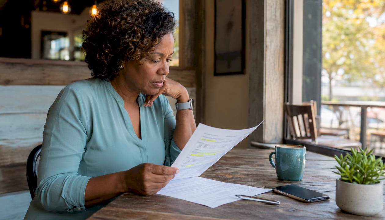 Hands pointing at insurance comparison checklist