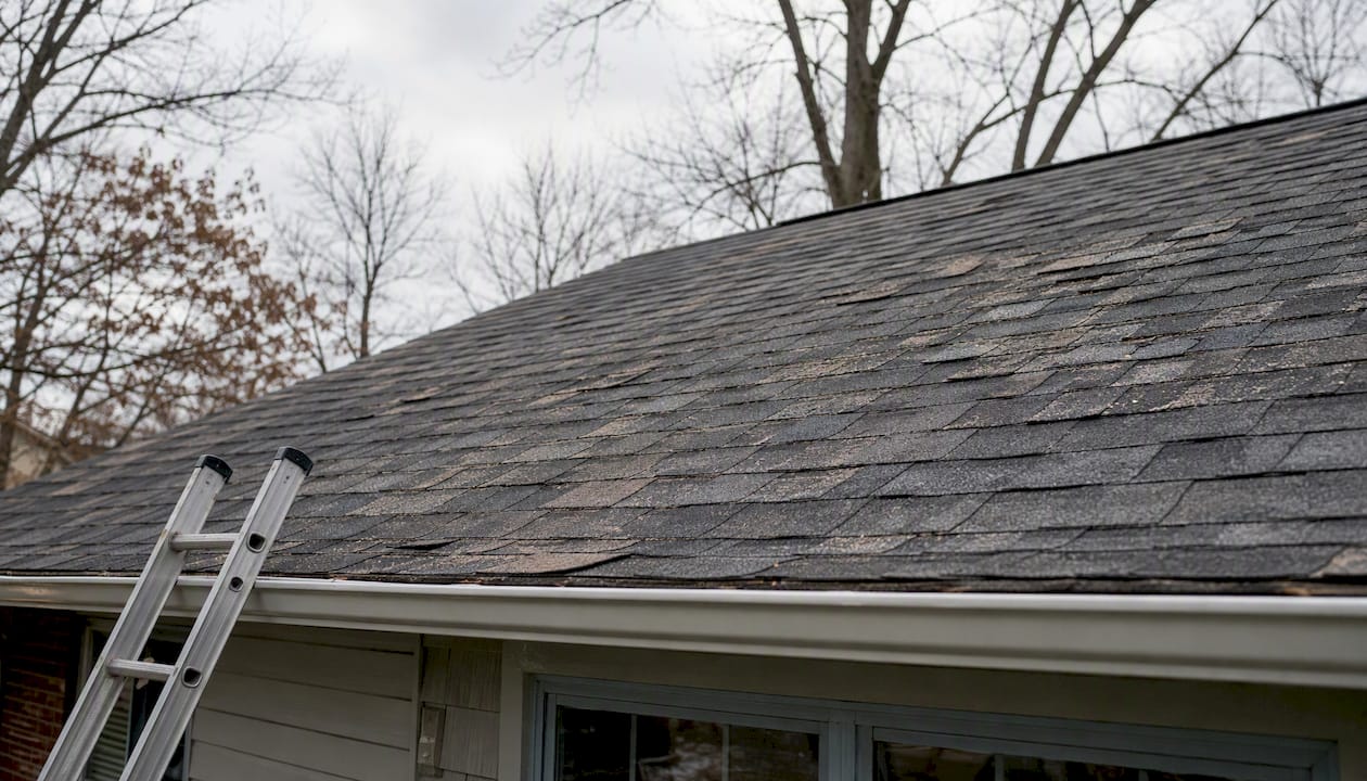 Storm damaged residential roof close-up