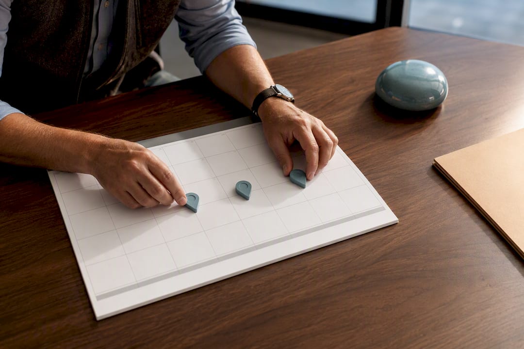 Hands organizing insurance renewal timeline markers