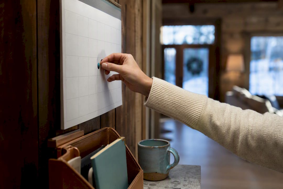 Hand marking an insurance renewal calendar