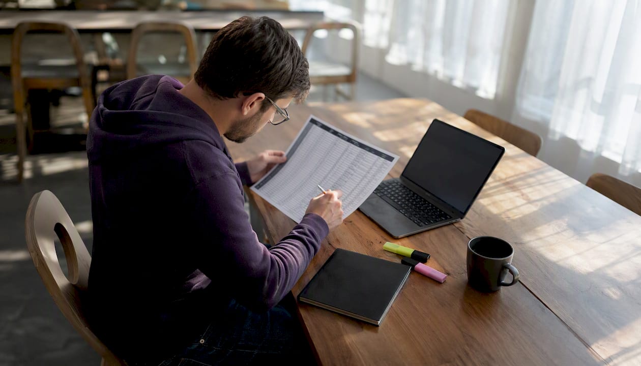 Developer working on link migration tasks at desk