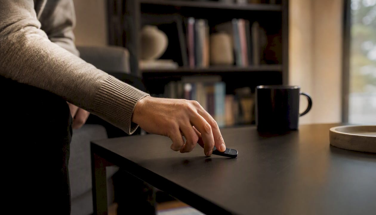 Hand holding privacy token near blurred server
