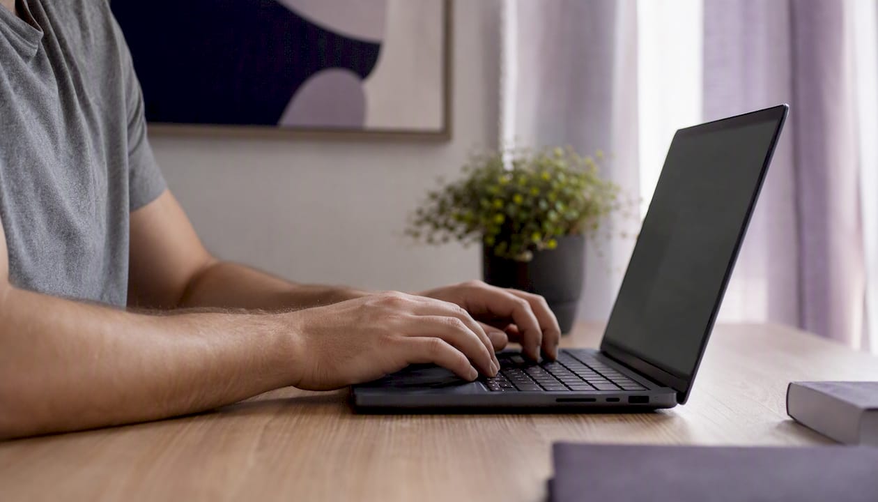 Hands exporting QR codes on laptop