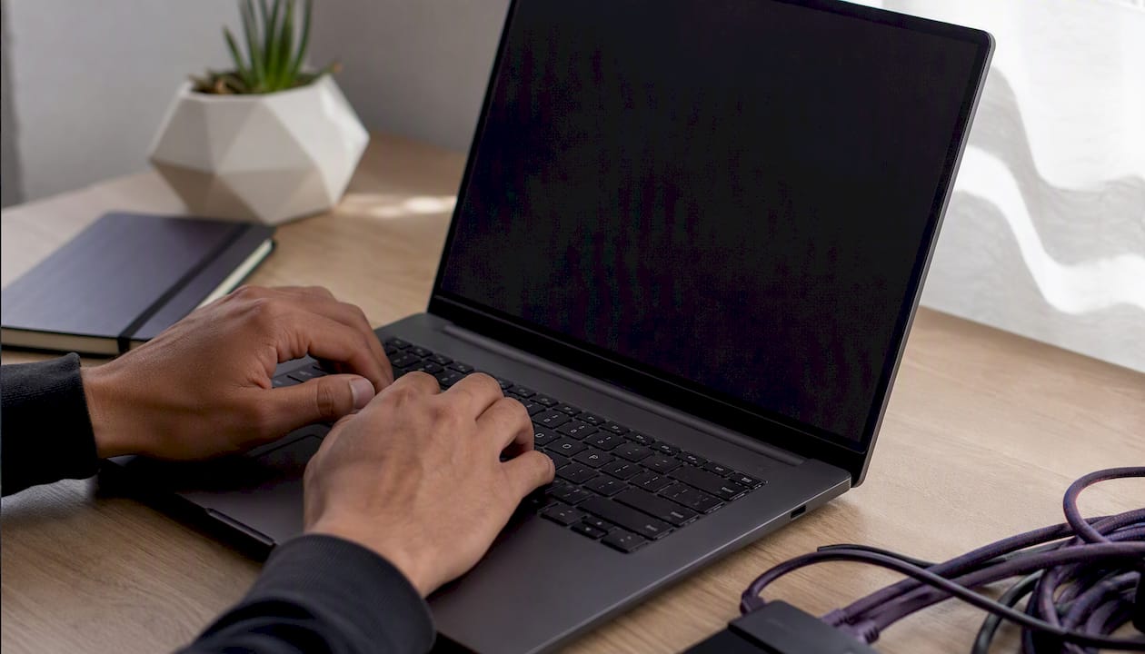 Hands typing curl command on laptop keyboard