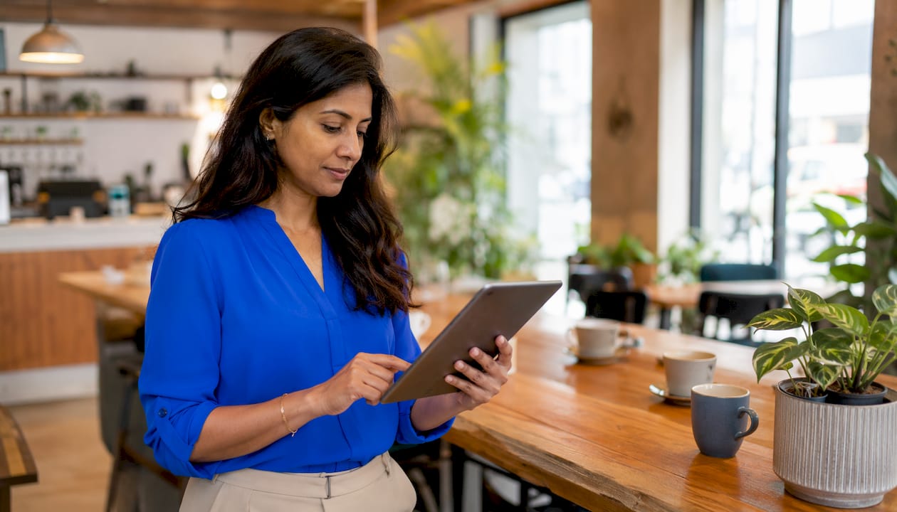 Business owner using tablet for AI scheduling