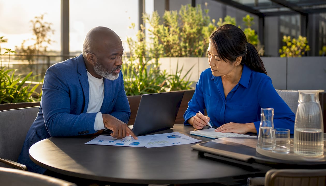Two colleagues reviewing AI virtual agent data