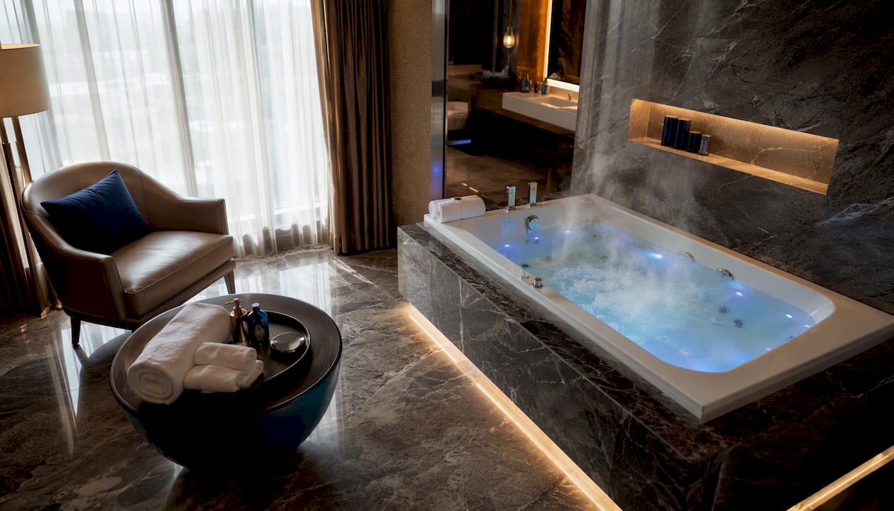Spacious hotel jacuzzi suite bathroom interior