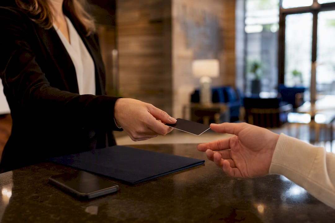 Hotel concierge handing over guest key card