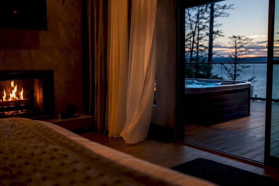 Hotel room fireplace and balcony with private tub