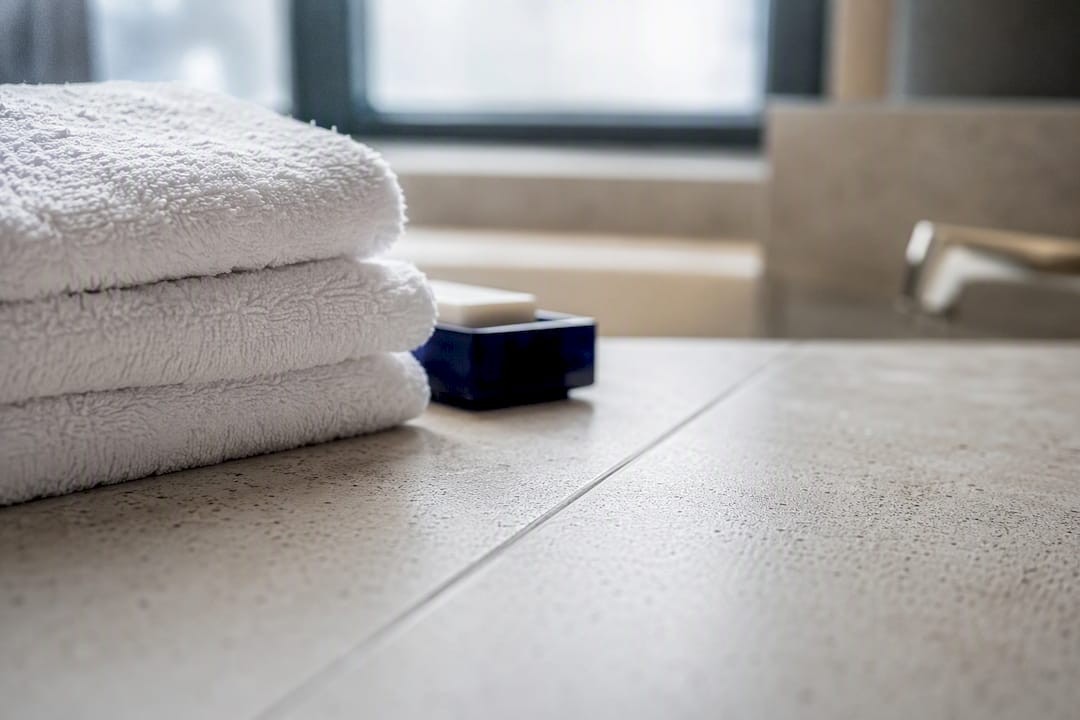 Clean hotel towels and bathroom grout