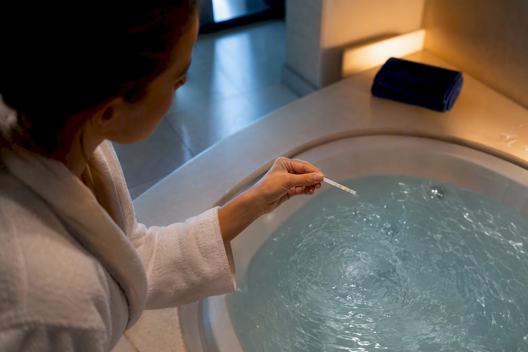 Guest checking jacuzzi water with test strip