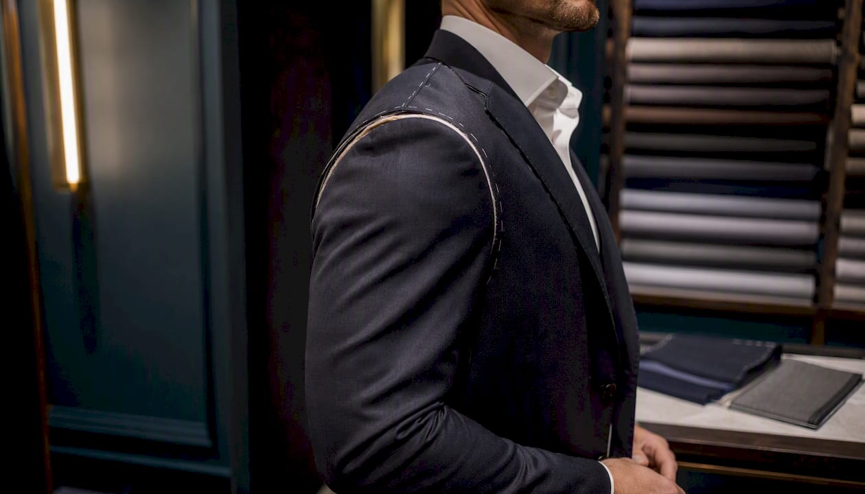 Side view of high armhole suit jacket on muscular arm