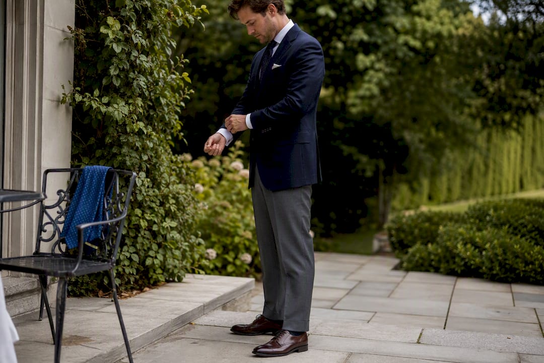 Man dressing in navy lightweight wool suit