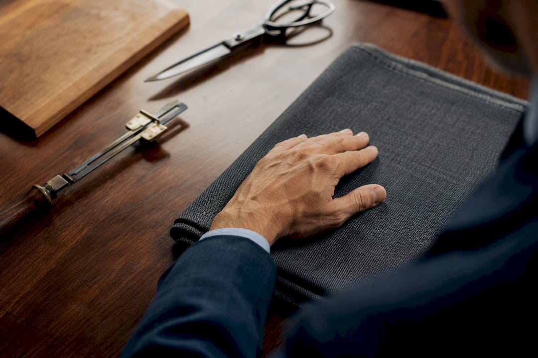 Hand touching pure worsted wool fabric