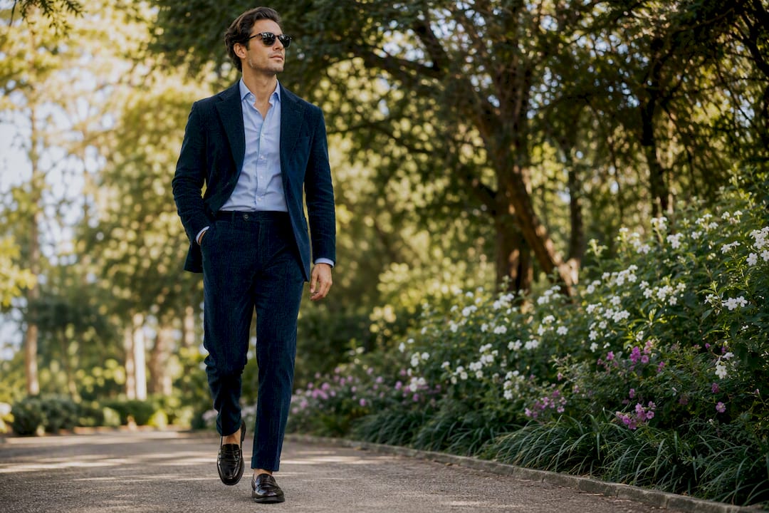 Man walking in navy tonal corduroy suit