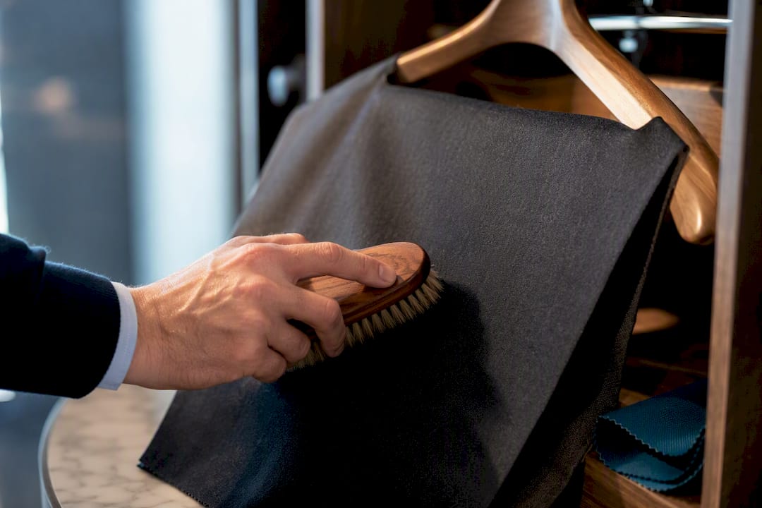 Tailor brushing wool suiting fabric