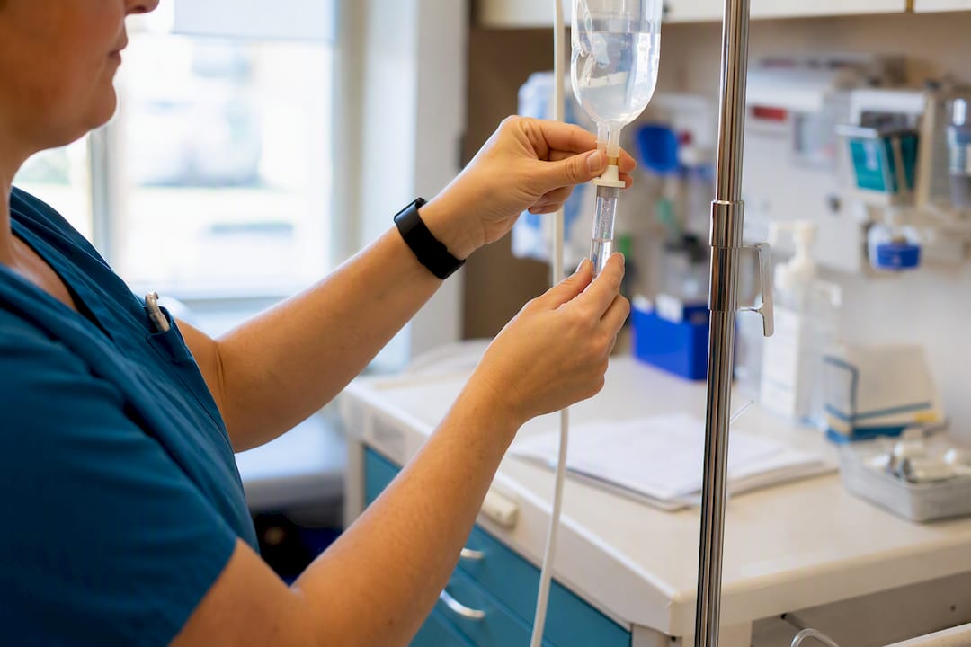 Nurse measuring IV fluid in clinical care