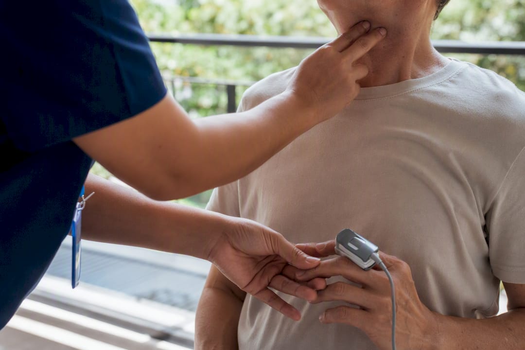 Nurse checking respiratory distress with pulse oximeter and palpation