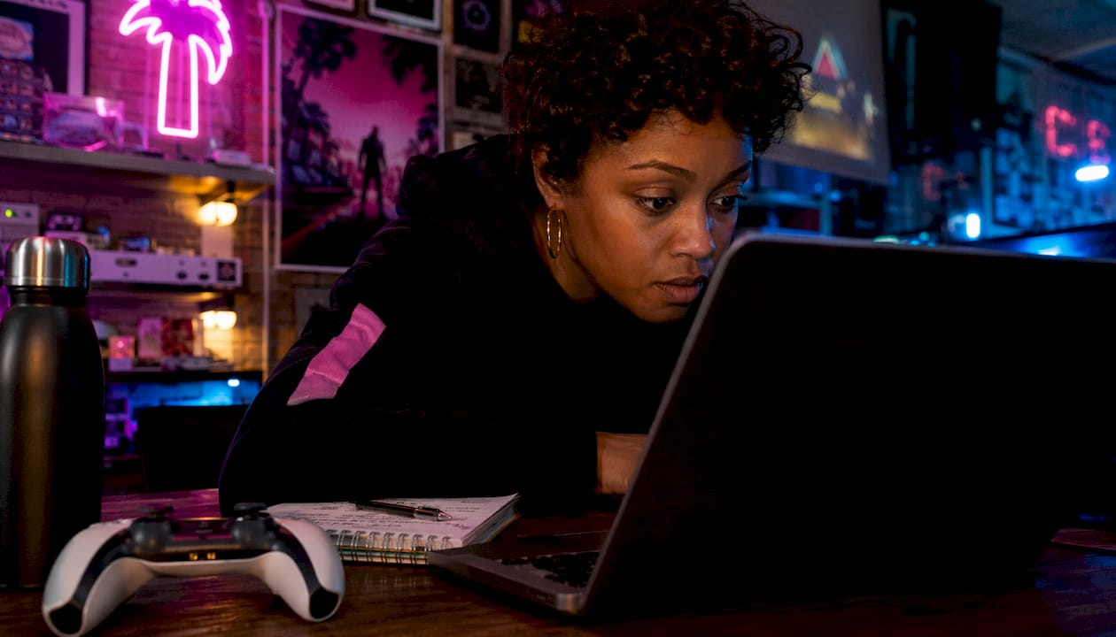 Woman preordering GTA 6 digitally on laptop