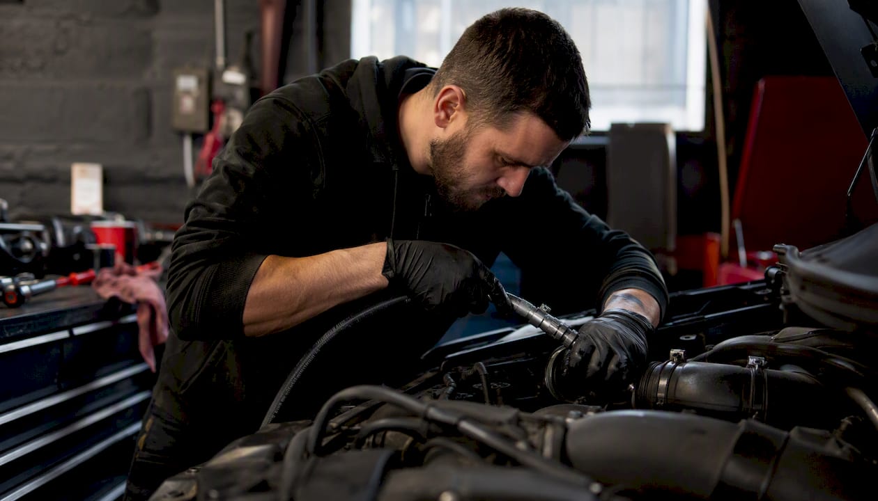 Technician connecting hydrogen cleaning machine to engine intake
