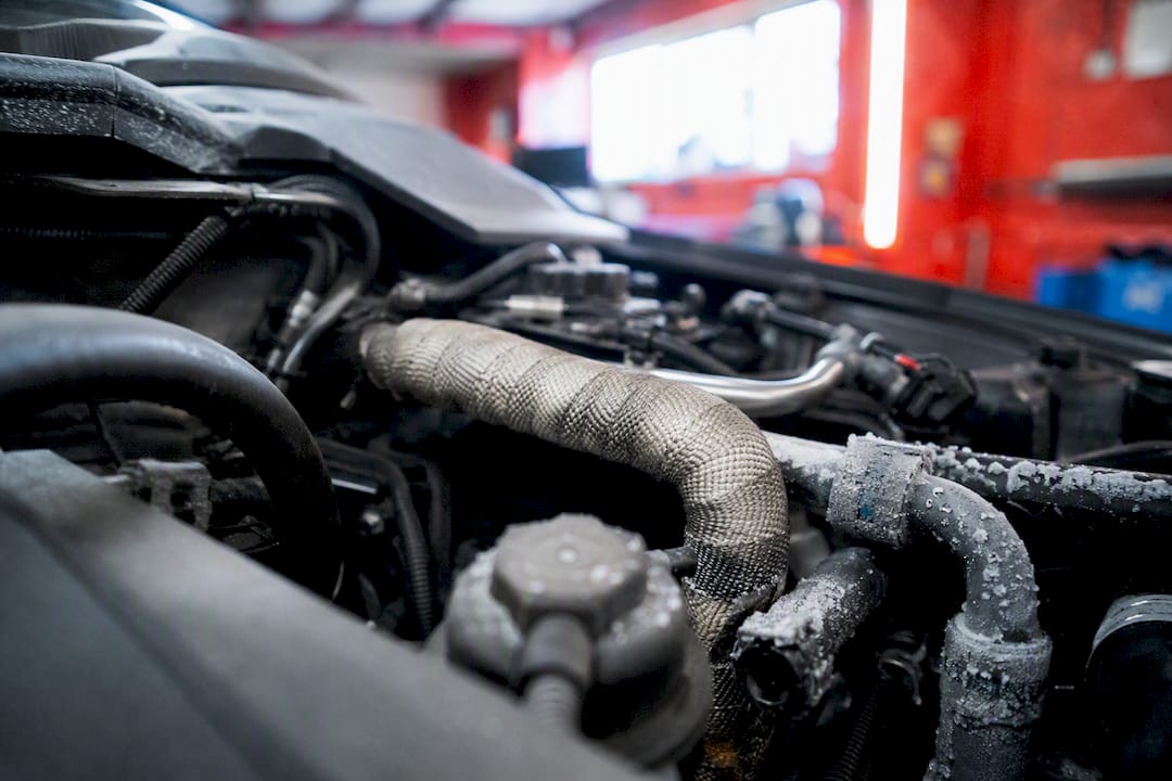 Heated fluid line in cold engine bay
