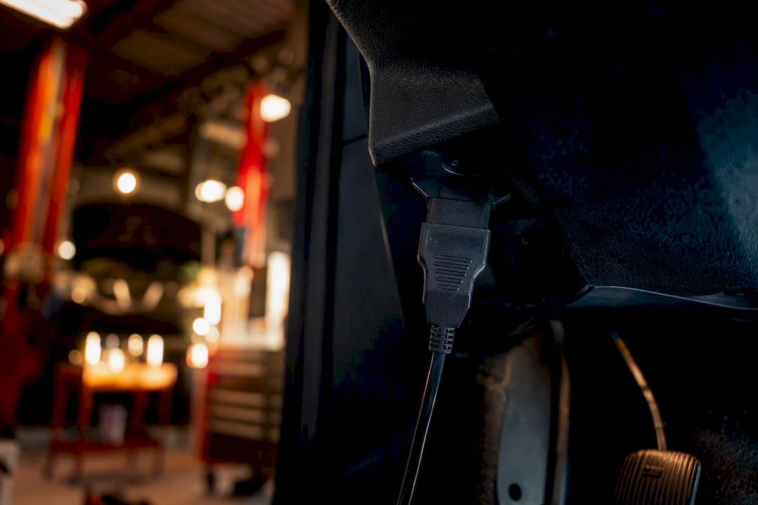 Diagnostic tool connected to car OBD port