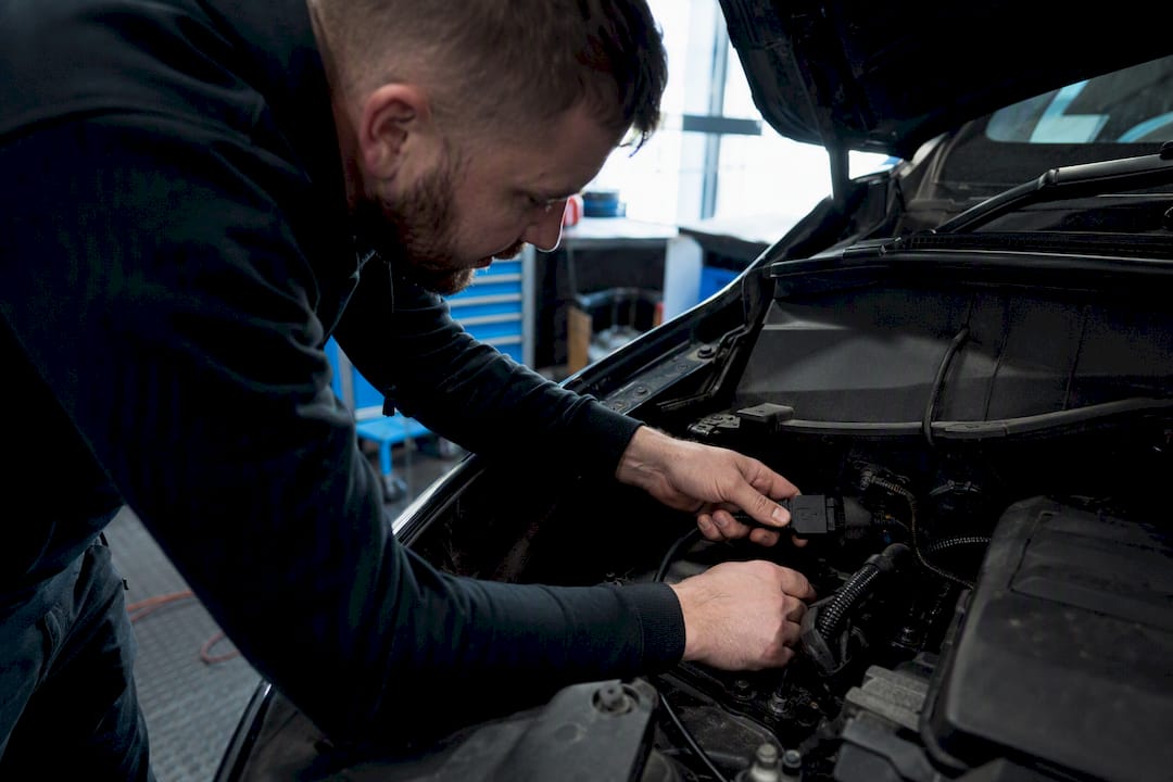 Technician connecting diagnostic tool to van’s engine port