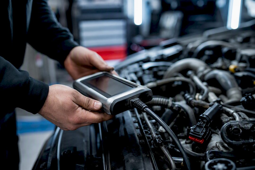 Handheld diagnostic scanner on diesel engine
