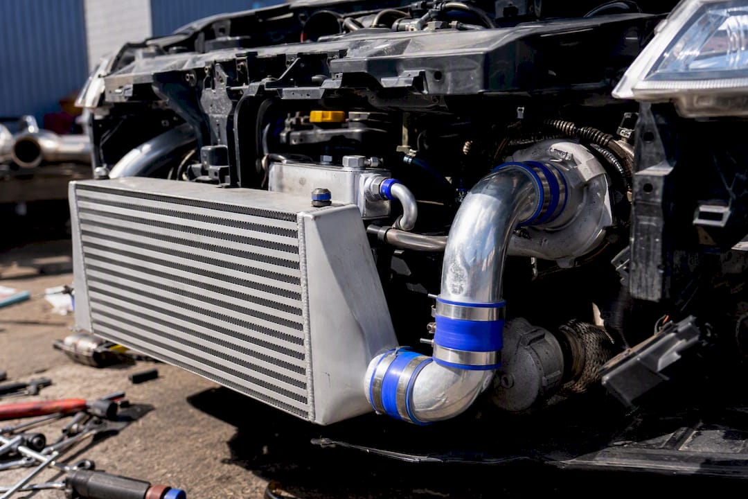 Close-up of upgraded intercooler and turbo in engine bay