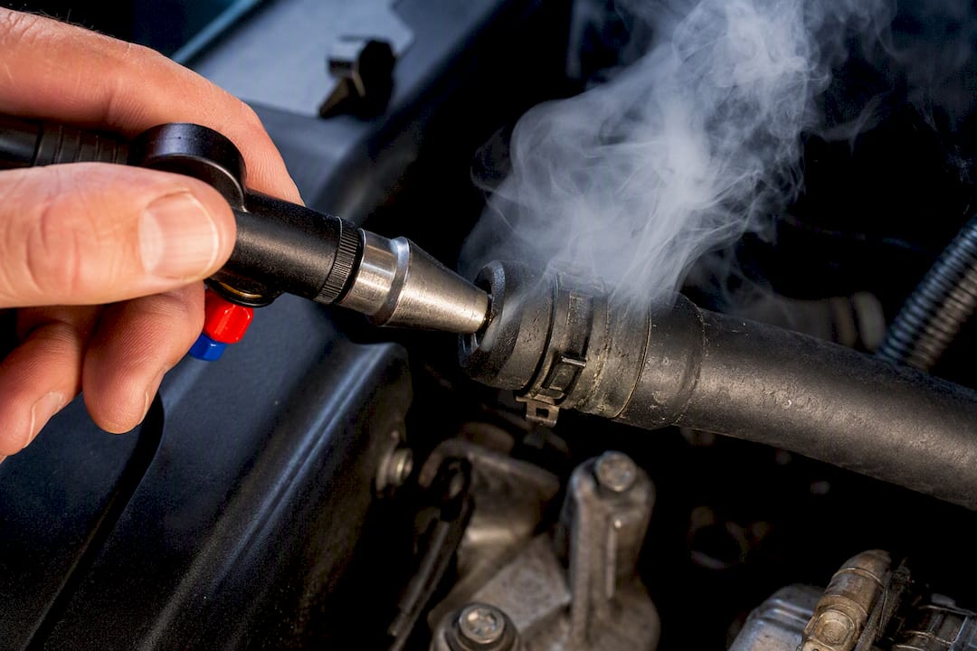 Smoke escaping from engine hose leak