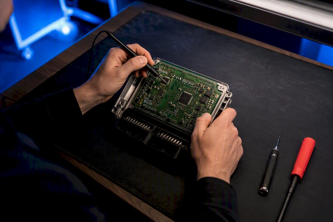 Technician inspecting an ECU circuit board
